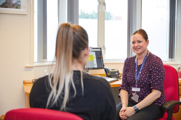 A photo showing Dr Middleton speaking to a patient